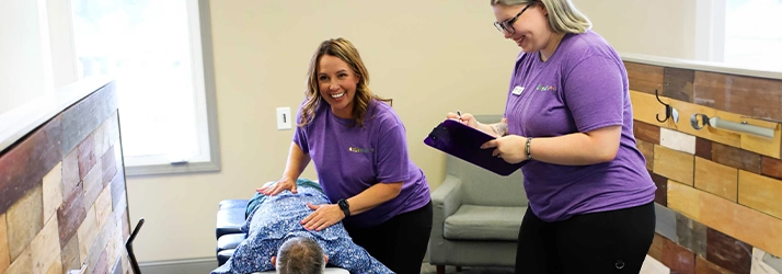Chiropractor Bloomington IL Jess Bruin With Team Adjusting Patient Chiropractor Bloomington IL Jess Bruin With Team Adjusting Patient